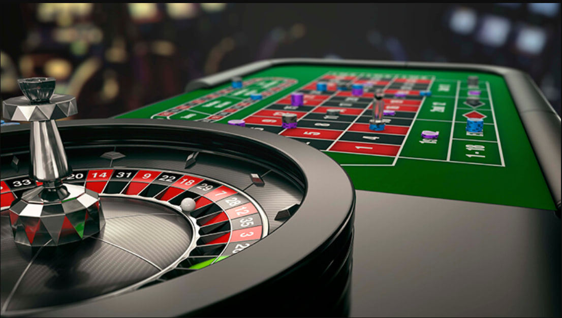A person happily playing casino games on a laptop or tablet at home.